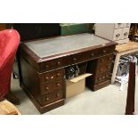19th century Mahogany Twin Pedestal Desk with Green Leather Inset Top above an arrangement of Nine