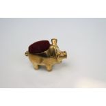 A brass pincushion in the form of a pig