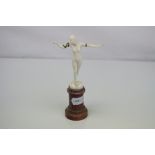 An Art Deco ivory figurine on a agate pedestal base signed G M Souilland.