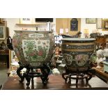 A large contemporary Cantonese style jardiniere on wooden stand together with one other similar.