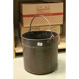 An antique copper coal / log bucket with studded strap work decoration.