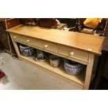 A large kitchen four drawer work table with underneath pot shelf