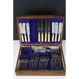 An oak cased Viners silver plated cutlery set .