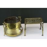 An arts and Crafts brass jardiniere together with an early 19th century brass trivet.