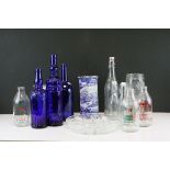 A quantity of vintage glass bottles to include milk, a blue and white hexagonal vase and glass