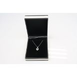 An 18ct white gold emerald and diamond pendant necklace of 40 points