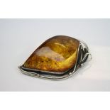 A hallmarked 925 sterling silver and amber brooch.