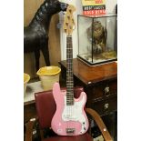 A pink Swift bass guitar .