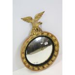 19th century Carved Giltwood and Ebonised Convex Mirror, the frame with ball mounts and surmounted