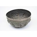 An Indian white metal bowl decorated with various deity's.