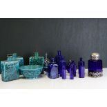 A quantity of blue glass items to include jugs bottles, vases bowls etc together with three tin