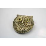 A brass cased vesta in the form of an owl with glass eyes