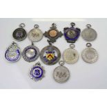 A collection of 12 x hallmarked silver fob medals.