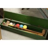 An early 20th century boxed croquet set.