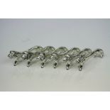 Set of Six White Metal Knife Rests in the form of Lions