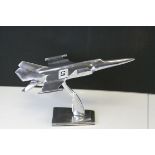 Art Deco style chrome fighter jet on stand