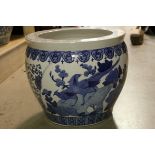 A large blue and white Chinese style fish bowl jardiniere.