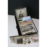 A metal box containing a quantity of coloured and monochrome postcards together with an early 20th
