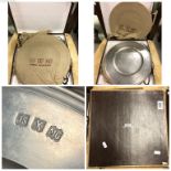 A boxed set of John Somers pewter plates