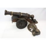 Carved Wooden Model of a Cannon, L.62cms and a Carved Wall Plaque in the form of a Face
