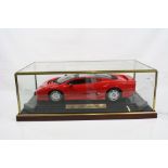 Cased 1:12 scale diecast Maisto Jaguar XJ220 (1992), model fixed to wooden plinth and well presented