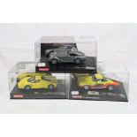 Three cased Carrera Evolution slot cars to include 27293 Morgan Aeromax, 25703 Ferrari Enzo yellow