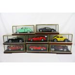 Eight cased 1:18 scale diecast model classic cars to include VW, Ferrari etc, models fixed to a