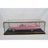 Cased 1:12 scale diecast Maisto Cadillac Eldorado, model fixed to wooden plinth and well presented