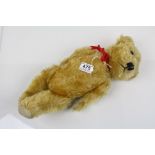 Mid 20th C straw filled teddy bear, some hair loss but gd overall