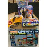 Four boxed vehicle play sets to include Matchbox Thunderbirds Tracy Island, Tyco Crash Dummies (with