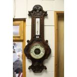 An oak cased early 20th century banjo barometer and thermometer.