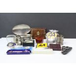 A box of mixed collectables to include hallmarked silver napkin rings, AA badges and a selection