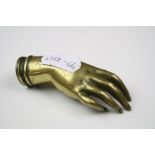 An antique brass wax seal in the form of a hand.