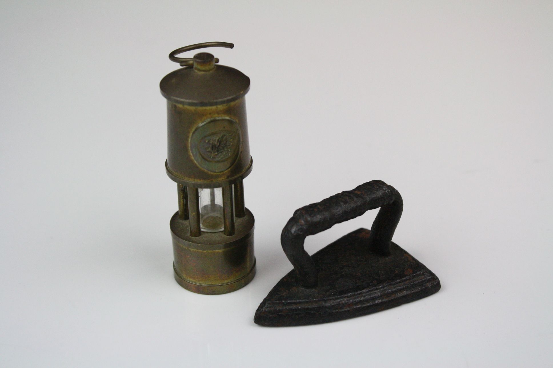 Miniature brass minors lamp together with a miniature flat iron.