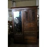 Victorian Mahogany Triple Wardrobe comprising Two Carved Panel Doors over Three Drawers flanked by a