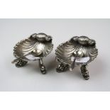 A pair of fully hallmarked sterling silver scalloped salts with oriental dolphin feet.