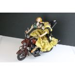 Two Spanish Dolls on a Tin Plate Motorbike