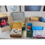 A large quantity of slides contained in three boxes plus one other cased set .and a suitcase of