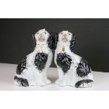 A pair of antique staffordshire spaniel dogs.