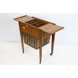 Mid 20th century Teak Sewing Table / Trolley, the top with pull back lids opening to reveal a fitted
