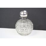 A cut glass scent bottle with fully hallmarked sterling silver hinged lid, complete with stopper.