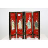 Japanese Black and Red Lacquered Four Fold Table Screen, inset with hard stone figures, each panel