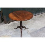 George III Circular Tilt Top Table raised on turned baluster support with three splayed legs,