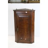 Georgian Oak Hanging Corner Cupboard, the single panel door opening to reveal three shaped