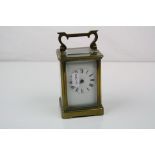 A brass cased carriage clock with white enamel dial, complete with key.