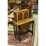 Late 19th century Walnut Ladies Sewing Table, the over-structure with two doors opening to reveal