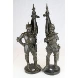 Pair of Bronze Figures in the form of Knights stood holding Flags, 60cms high