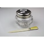 A cut glass powder jar with a fully hallmarked sterling silver lid together with a page turner with