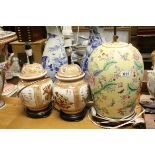 A pair of oriental lidded vases converted to lamps together with similar Famille Rose lamp.