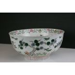 A 19th century floral decorated footed bowl the interior with decoration of figure with staff.